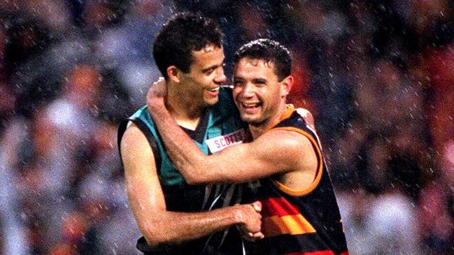 The image of Shane Bond (l) hugging brother Troy Bond during Port Adelaide vs. Adelaide Crows Showdown II at Football Park is used on the Showdown trophy. Picture: Football/AFL