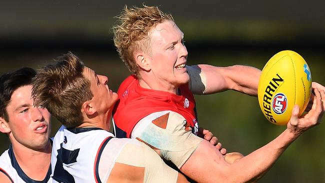 Matt Crouch wraps up Clayton Oliver during the weekend’s Marsh Series game at Casey Fields. Picture: Quinn Rooney/Getty Images