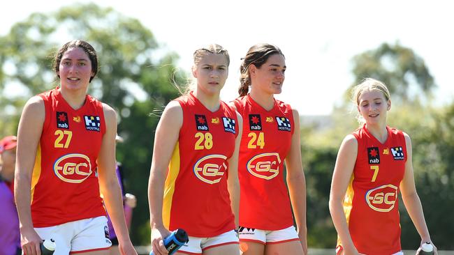 SUNSHINE COAST, AUSTRALIA - SEPTEMBER 19: Dekota Baron, Chloe Gaunt, Georja Davies and Sunny Lappin of the Gold Coast Suns Academy Girls walk off the field after their victory during the AFL U16 Girls match between the Brisbane Lions and the Gold Coast Suns on September 19, 2022 in Sunshine Coast, Australia. (Photo by Albert Perez/AFL Photos via Getty Images)