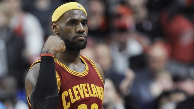 Cleveland Cavaliers' LeBron James pumps his fist after scoring during overtime of an NBA basketball game against the Chicago Bulls in Chicago, Friday, Oct. 31, 2014. Cleveland won 114-108 in overtime. (AP Photo/Paul Beaty)