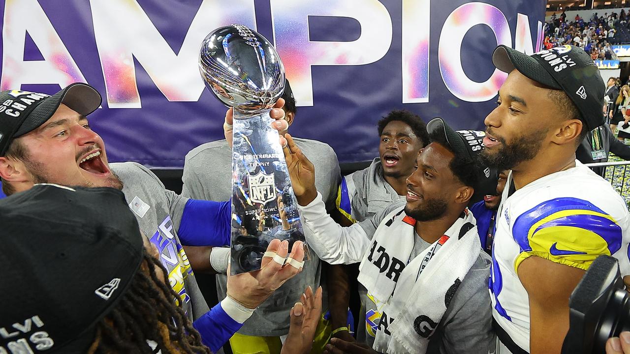 Los Angeles Rams players celebrate with the Vince Lombardi Trophy. Photo by Kevin C. Cox/Getty Images.