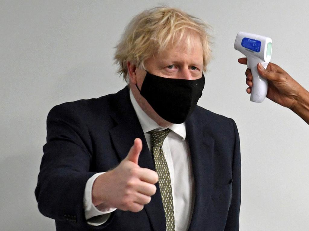 Prime Minister Boris Johnson gives a thumbs up as he has his temperature checked. Picture: AFP