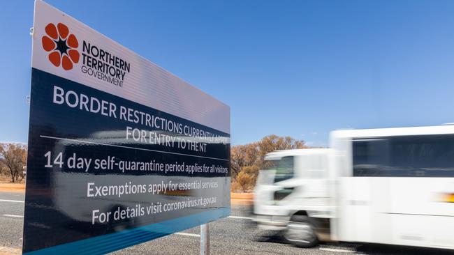 The new signs at the NT/SA border advising of the new restrictions on entering the Territory. Picture: Emma Murray