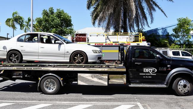 Queensland Police and Queensland Fire Department officers respond to an emergency at the General Aviation area of the Cairns Airport, where a man suffered life threatening injuries after being crushed by a car in the carpark of Hinterland Aviation. The car is removed from the Hinterland Aviation carpark. Picture: Brendan Radke