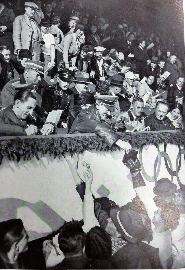 Hitler signs autographs for Olympic athletes and German crowds. Picture: Reproduced with permission from The Scandalous Freddie McEvoy, by Frank Walker (Hachette)