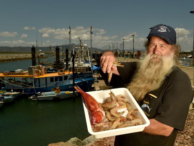 Lounds Seafood owner Col Lound with a coral trout and banana prawns in front of the Dorothy B with specialises in catching coral trout. Picture: Evan Morgan