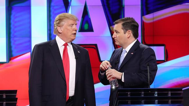 Donald Trump and Ted Cruz confer during a break in presidential primary debate in Miami in March 2016. Picture: AFP