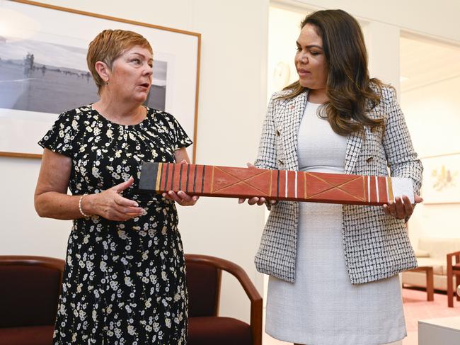 CANBERRA, AUSTRALIA  - NewsWire Photos - February 12, 2025: Margaret Andrews, wife of the late Liberal MP Kevin Andrews hands Senator Jacinta Price a message stick her husband was given by Aboriginal people from the NT for his move to ban voluntary assisted dying. NCA NewsWire / Martin Ollman