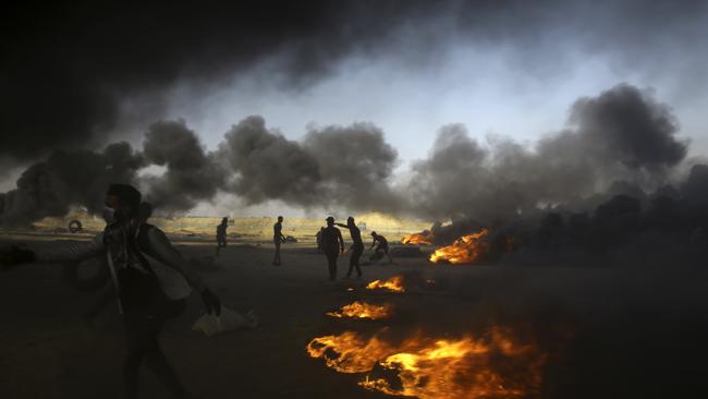 Palestinian protesters burn tires during a protest at the Gaza Strip's border with Israel, east of Khan Younis, Picture: AP