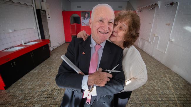 After 50 years and 7 months Rinos Unisex salon has closed forever. Josie Minniti kisses her husband Rino Minniti at the salon in Lalor. Picture: Tony Gough