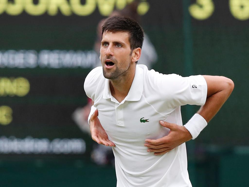 Djokovic getting ready to perform his trademark gesture of showering the crowd with love.