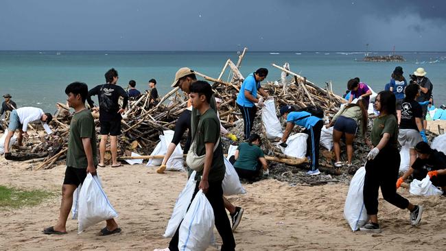 Participants and volunteers remove plastic waste and other garbage washed ashore at a beach in Kedonganan Badung regency, Indonesia's Bali island. Picture: AFP