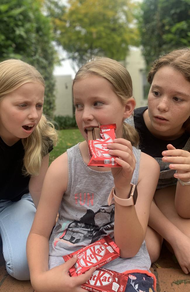 Scarlett O’Connell, nine, keeps an eye on her KitKat chocolates from her sisters Soraya, 10, and Lucinda, 12. Picture: Lachlan Miranda