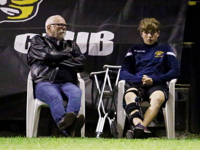 Edge Hill striker Ben McDonnell (right) sits on the sideline with a broken knee. Picture: Brendan Radke