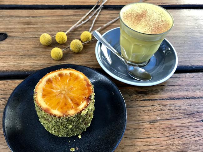 The gluten free orange, almond and pistachio cake and a turmeric latte. Picture: Jenifer Jagielski