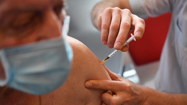 An elderly man receives a dose of the Pfizer-BioNtech Covid-19 vaccine, at a vaccination centre in Quimper, western France, on February 16, 2021. (Photo by Fred TANNEAU / AFP)