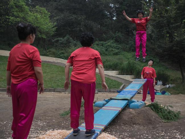 Women practice a traditional see-saw game at a park in Pyongyang. Picture: Ed Jones/AFP