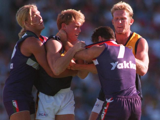 Jess Sinclair and Heath Black tangle with Michael Braun in a heated Western Derby in 1999.