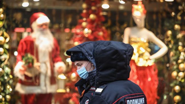 Russian police officers wearing face masks walk along the touristic Arbat street in Moscow. Russian President Vladimir Putin has told health officials to start widespread Sputnik V vaccinations in the coming week. Picture: AFP