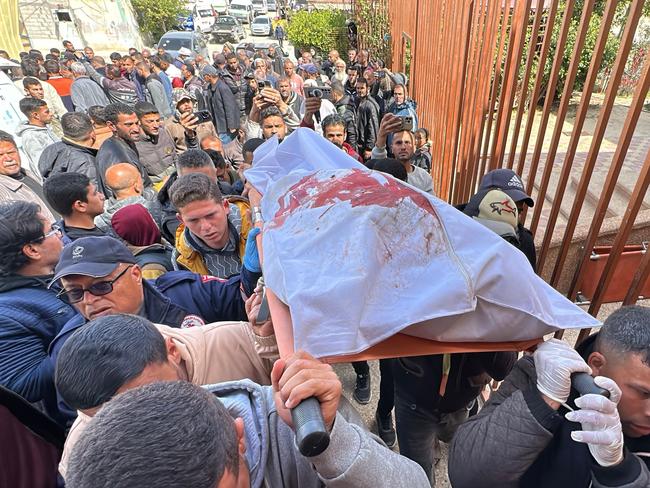 Palestinians carry the body of a man, one of two men killed by the Israeli army, which said it had struck a "suspicious motorised vessel" off Khan Yunis in southern Gaza, and separately opened fire on two suspects who it said posed a threat. Picture: AFP