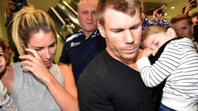 Australian cricketer David Warner (C), his wife Candice and their daughters leaving the airport after arriving back in Sydney from the last tour of South Africa. Picture: AFP PHOTO/Peter Parks