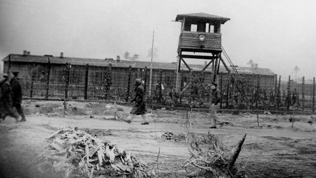 Stalag Luft III was supposed to be inescapable, so the Nazis were especially incensed by the March 1944 breakout. Here, prisoners are pictured walking past a watchtower around the camp perimeter in the winter months, to keep fit and stay warm.