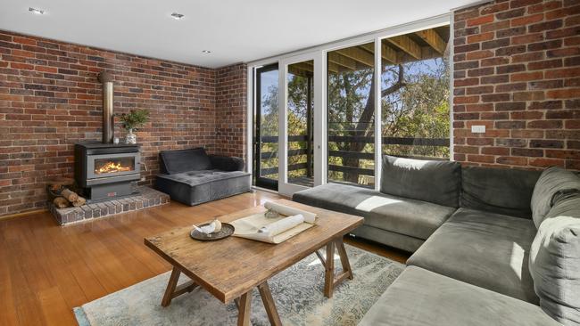 The downstairs lounge has a wood heater and its own balcony.