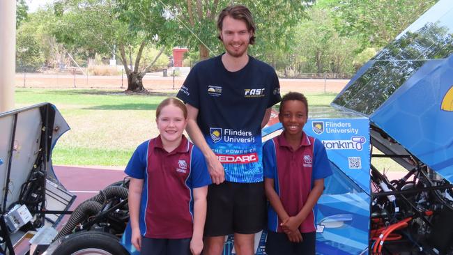 Palmerston CC students Isla Holgate and Naz Mburu standing with NT’s own and team member Ethan Taylor, Monday, October 16, 2023.