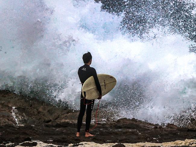 Wet weather and windy conditions on the Gold Coast.Surfers enter the rough surf at Snapper Rocks.Picture: NIGEL HALLETT