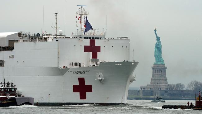 The 1000-bed USNS Comfort medical ship moves up the Hudson River in New York, where hospitals have been overwhelmed by coronavirus patients. Picture: AFP