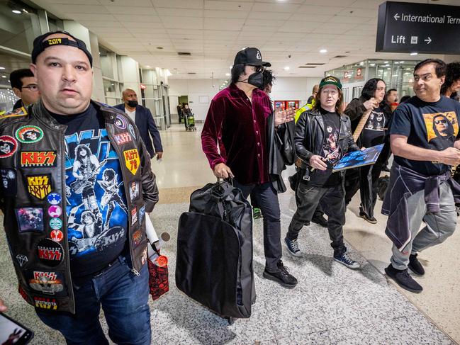 Gene Simmons is flanked by fans upon arrival at Melbourne Airport to begin the Australian leg of the End of the Road Tour. Picture: Jake Nowakowski
