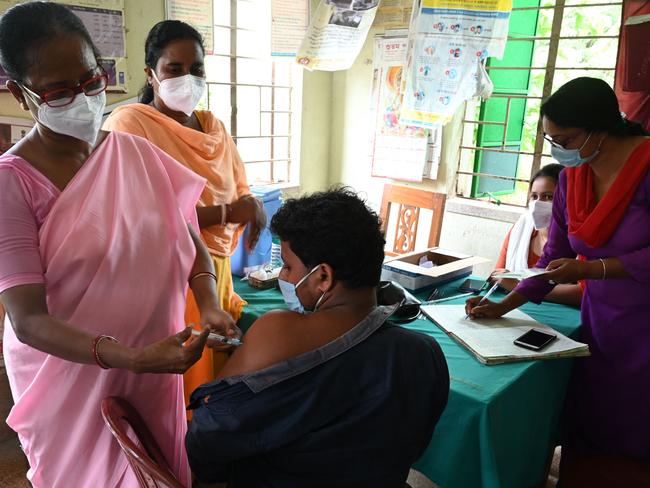 A health worker inoculates a man with a dose of the Covishield vaccine against Covid-19 coronavirus during a vaccination drive in India. Picture: AFP