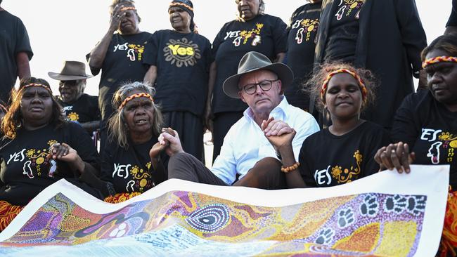 Prime Minister Anthony Albanese with a painting of the Uluru Statement from the Heart in Uluru during the last week of the referendum campaign. Picture: NCA NewsWire / Martin Ollman