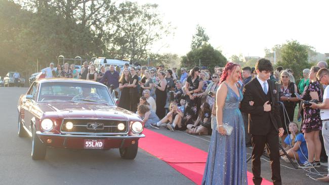 Audrey Ellison and Jake Gillespie arrived in a candy-apple red 1967 Ford Mustang.