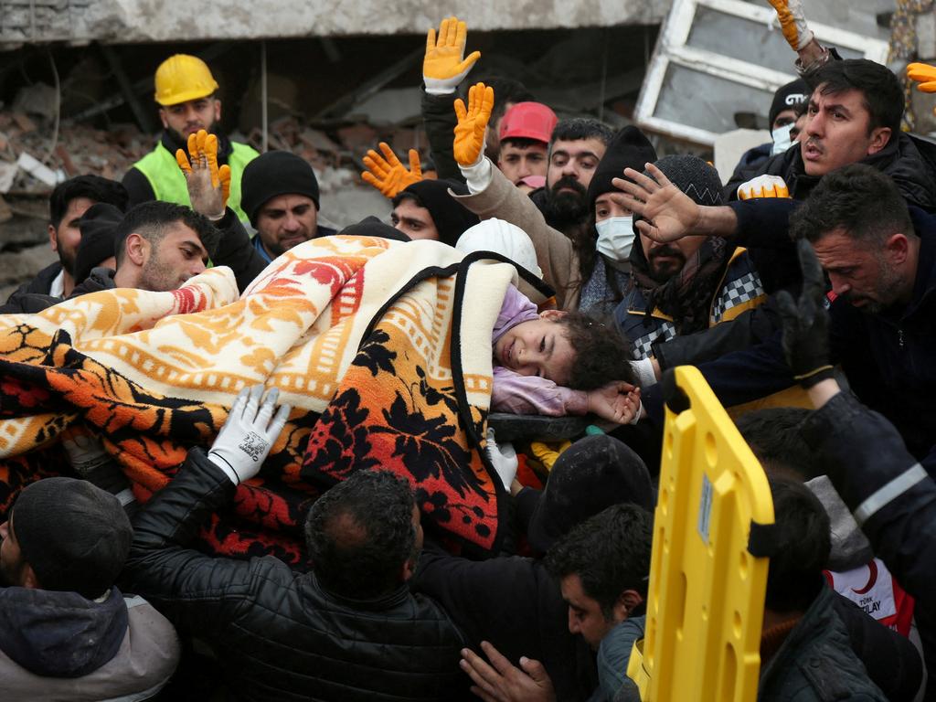 Rescuers carry out a girl from a collapsed building following an earthquake in Diyarbakir, Turkey. Picture: Reuters.