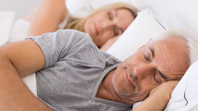 Senior man and woman sleeping. Senior man and woman resting with eyes closed. Mature couple sleeping together in their bed.