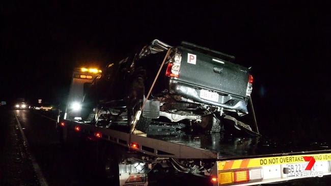 The wrecked Toyota HiLux ute is towed from the scene on Sunday night. Picture: 7NEWS