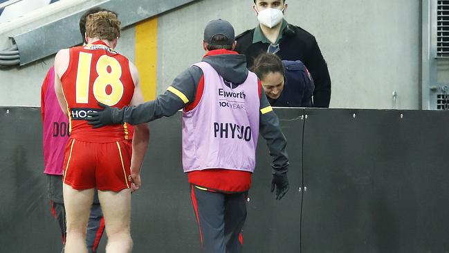 Rowell leaves the field with Suns’ doctor and physio after the injury. Picture: Daniel Pockett/Getty Images