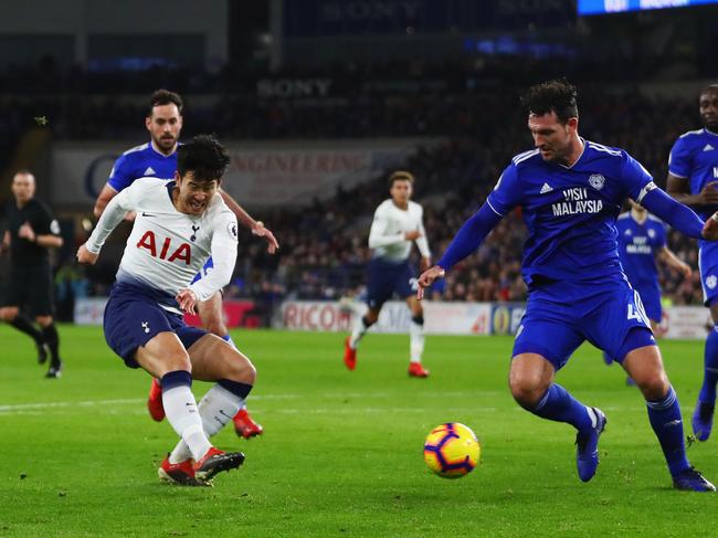 CARDIFF, WALES - JANUARY 01:  Heung-Min Son of Tottenham Hotspur shoots past Sean Morrison of Cardiff City as he scores his team's third goal during the Premier League match between Cardiff City and Tottenham Hotspur at Cardiff City Stadium on January 1, 2019 in Cardiff, United Kingdom.  (Photo by Michael Steele/Getty Images)