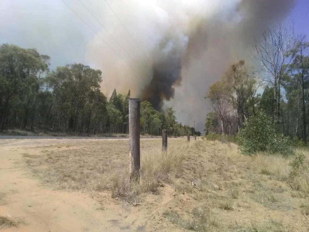 Doug Grist took this photo as he fled property at the corner of Primrose Road and Ayers Rock Road. The smoke is coming from his neighbours home, which he said was destroyed.