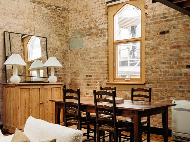 The Elizabeth’s dining area which features a table sourced from New Norfolk’s Drill Hall Emporium, and arched windows, the light from which illuminates the structure’s raw, exposed, original red bricks. Picture: AARON JONES.