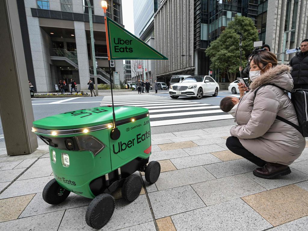 Uber Eats’ boxy robots have square headlights for eyes and three wheels on each side to navigate kerbs as they calculate routes on their own, using sensors to avoid pedestrians and other obstacles.