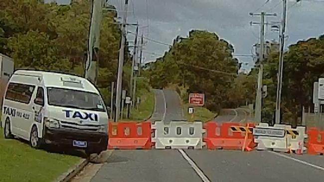 A taxi crossing the NSW border by driving around the barriers at Kirra on the Gold Coast. Picture: Gold Coast Bulletin