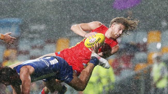 Action from the AFL match between the Gold Coast Suns and the North Melbourne Kangaroos, held at Cazalys Stadium, Cairns. Gold Coast's Aaron Young takes a spectacular mark. PICTURE: BRENDAN RADKE