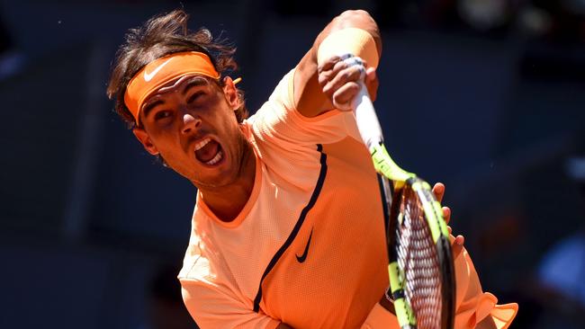 Spanish player Rafael Nadal serves a ball to Russian player Andrey Kuznetsov.