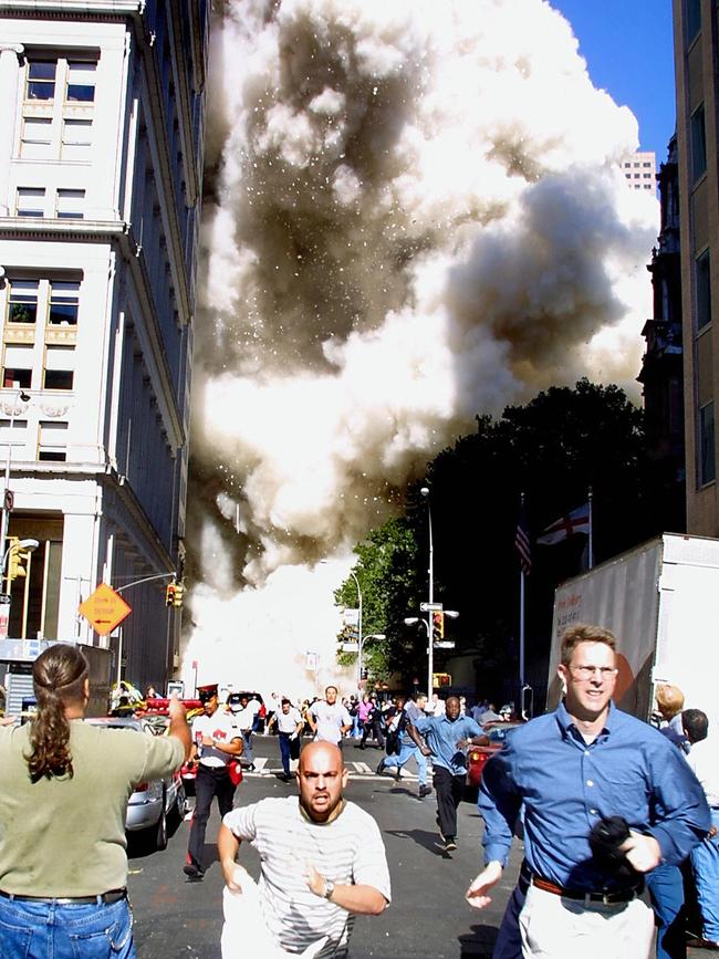 Pedestrians running from the scene as one of the World Trade Centre towers collapses on September 11, 2001. Picture: AFP