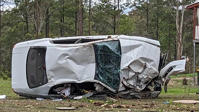 A car rolled over and smashed into a power pole in Glenwood on Tuesday morning, November 28, 2023. The accident knocked the pole over and has left five neighbouring streets with a power outage. Photo: Brock Sutton