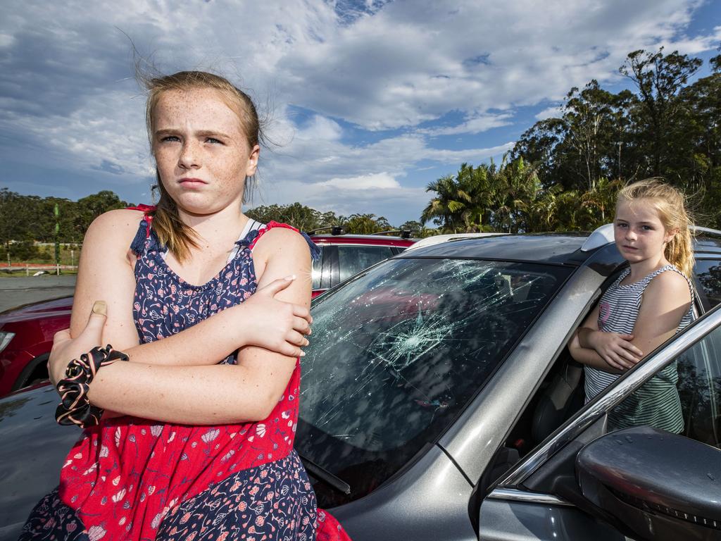 Sisters Izabella 10, and Chelsea Redman 7 from the Gold Coast, were in the car with dad Jason on the Bruce Highway at Glenview when a wild hailstorm hit causing chaos on the roads smashing windscreens and causing widespread damage. Photo Lachie Millard