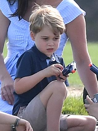 The Duchess of Cambridge sat beside her son, Prince George, while he played with the gun. Picture: Mega.