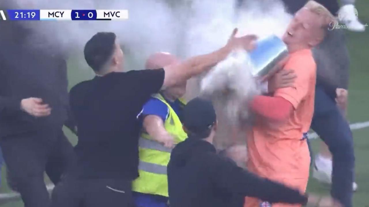 City goalkeeper Tom Glover is assaulted with a bin as fans invade the pitch.